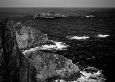 Fotografía de paisaje de costa con rocas en blanco y negro